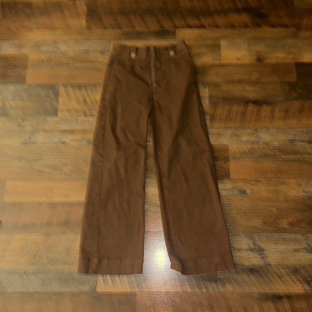 Wide flair brown jeans. I’m 5’7” and the cut off at my shins.